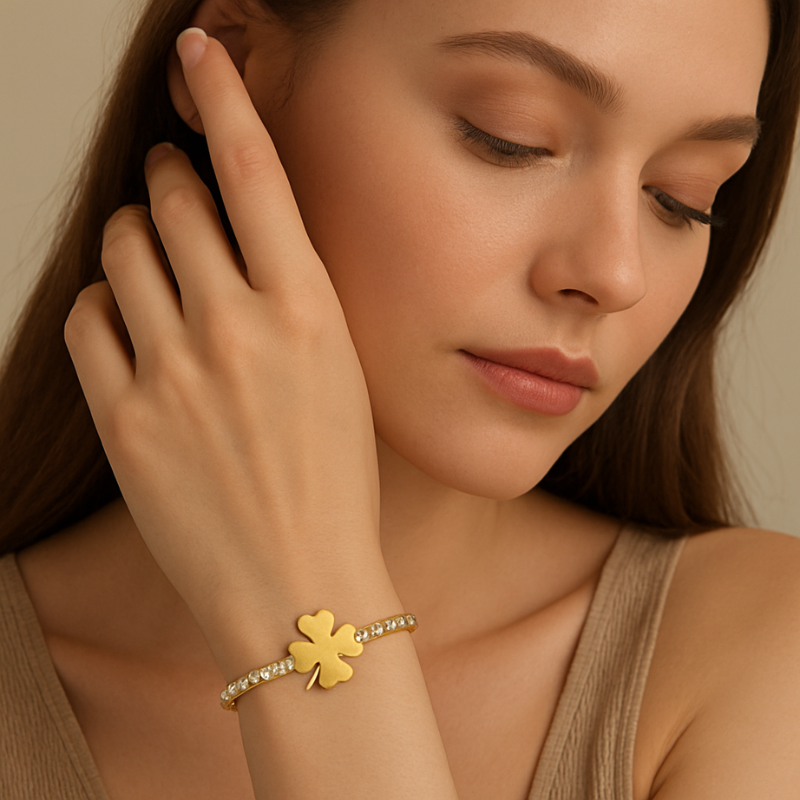 Gold Bracelet with a four-leaf clover charm and diamond-like stones